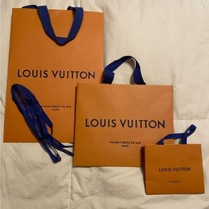 Set of 3 Authentic Louis Vuitton shopping bags and ribbon.